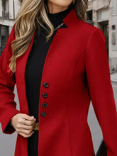 A vibrant red button up long sleeve coat with black buttons and a sleek collar in tailored design