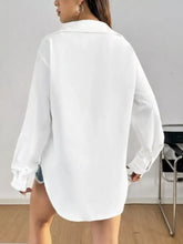 White oversized button-up long sleeve shirt with classic collar made of lightweight fabric for casual and formal wear