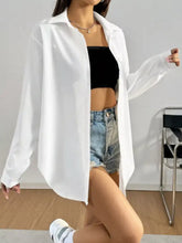 White oversized button up long sleeve shirt with relaxed fit made from lightweight breathable fabric