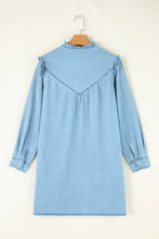 Light blue denim dress with ruffled shoulder details and gathered back neckline in notched long sleeve style