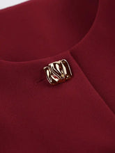 Gold shell brooch on neckline of Button Up Peplum Blazer red fabric