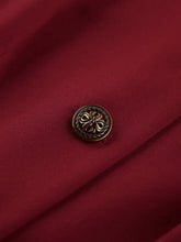Ornate brass clover button on Button Up Peplum Blazer red fabric