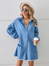 Light blue denim dress with button-front closure, ruffled sleeves, pocketed raw hem, and frayed edges