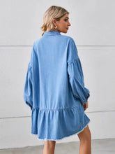 Light blue denim dress with ruffled sleeves and raw hem featuring button up and pocketed raw hem details