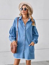 Blue denim dress with puffed sleeves and raw hem featuring pockets in a button up pocketed raw hem denim dress