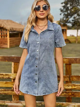 A short sleeve mini denim dress in blue with button front and classic denim fabric design