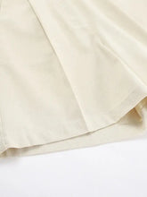 Cream-colored cotton Button Up Vest and Shorts Set with textured weave and stitched hem