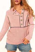 Women’s buttoned long sleeve hoodie in pink with dark stitching and buttons
