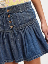 Blue buttoned ruffled mini denim skirt with gathered waist wooden buttons and elasticated drawstring closure