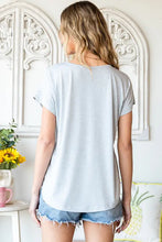 Light blue Buttoned V-Neck Tee with regular sleeve length and rounded hem