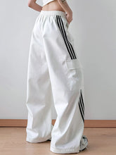 White striped wide leg cargo pants with black三条 stripes and a large front pocket for casual wear