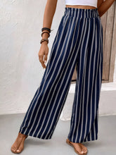 Navy blue and white striped wide leg pants with an elastic waistband featuring easy care instructions