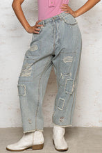 Light-wash denim wide leg pants with vertical pinstripes and distressed raw hem patchwork rips
