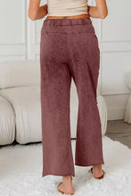 Mauve wash wide leg pants with elastic waistband and soft textured fabric featuring easy care instructions