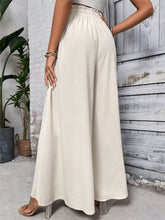 Cream-colored high-waisted frill wide leg pants with elastic waistband and flowing relaxed fit wide leg pants