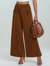 Brown high-waisted wide leg pants with elastic band and two front pockets for comfortable wear