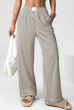 Beige and black vertically striped wide-leg trousers with elastic high waist and pockets for comfortable wear