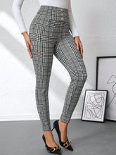 High waist black and white plaid slim fit pants with button detail at the waist for a stylish look