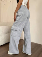 Gray heathered casual drawstring loose fit cargo pants with large flap pockets and a relaxed wide-leg cut