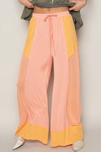 Pol drawstring wide leg pants in pastel pink and mustard yellow with sheer mesh side panels and a drawstring waistband