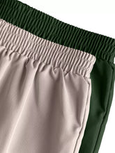 A pair of soft cargo pants with elastic waist in muted beige and deep forest green from 2 piece elastic waist set