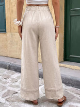 Beige linen casual wide leg pants with drawstring waist and delicate lace trim at the hem