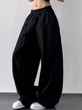 Black oversized wide leg casual pants with elastic waistband and flowing silhouette machine wash tumble dry care instructions