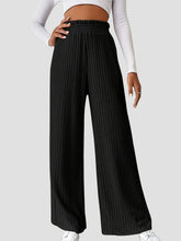 Black ribbed high waist pants with pleated wide legs and elastic waistband for comfortable wear