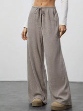 Beige corduroy relaxed fit wide leg pants with a drawstring waist for comfortable casual wear