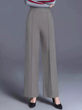 Gray high-waisted wide leg pants with smooth tailored fabric and vertical pleats, machine wash and tumble dry care instructions