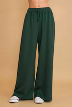 Dark green Umgee wide leg pants with elastic waistband and adjustable drawstring for comfortable wear