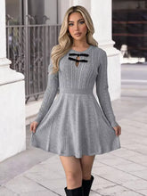 Gray cable-knit A-line sweater dress with black lace-up neckline