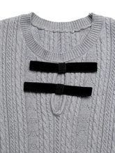 Gray cable-knit A-line sweater dress with black velvet bows on chest