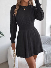 Black cable-knit sweater dress with heart pattern and ribbed details