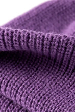 Close-up of vibrant purple rib-knit beanie fabric texture