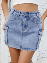 Light-wash cargo denim skirt with button closure and cargo pockets ideal for casual wear and easy care instructions