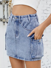 Light-wash cargo denim skirt with button closure and cargo pockets in a stylish denim skirt design