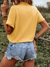 Yellow short-sleeved polo shirt with collar and relaxed fit featuring a casual drawstring hem shirt design