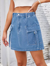 Blue denim skirt with multiple cargo pockets and button closure designed as a casual cargo denim skirt