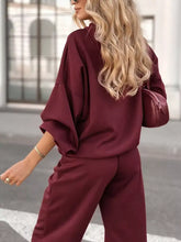 Maroon satin tracksuit set with loose 3/4 sleeve top and wide-leg pants
