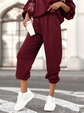 Maroon satin joggers with elastic waistband and cuffed hems from Casual Hoodie and Cropped Pants Set