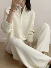 Cream-colored ribbed knit sweatsuit with half-zip front and wide-leg pants