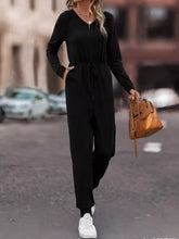 Black long-sleeved jumpsuit with drawstring waist, side pockets, machine wash cold