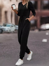Black long-sleeved v-neck jumpsuit with drawstring waist, machine wash cold