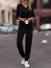 Black long-sleeved v-neck jumpsuit, machine wash cold, tumble dry low
