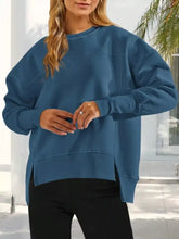 A soft teal-blue casual loose side slit sweatshirt with relaxed fit suitable for machine wash cold care