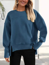 A teal oversized knit casual loose side slit sweatshirt with ribbed cuffs designed for machine wash cold care