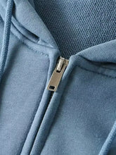 Light blue casual loose zip-up hoodie with ribbed knit fabric and metallic zipper pull suitable for machine wash cold