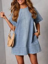 Light blue denim dress with short sleeves and a relaxed a-line silhouette casual short sleeve denim dress