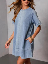 A light blue short sleeve denim dress with a relaxed fit perfect for casual wear denim dress